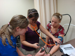 Students learn to take a patient's blood pressure at Northeast Iowa AHEC's Nurse Camp